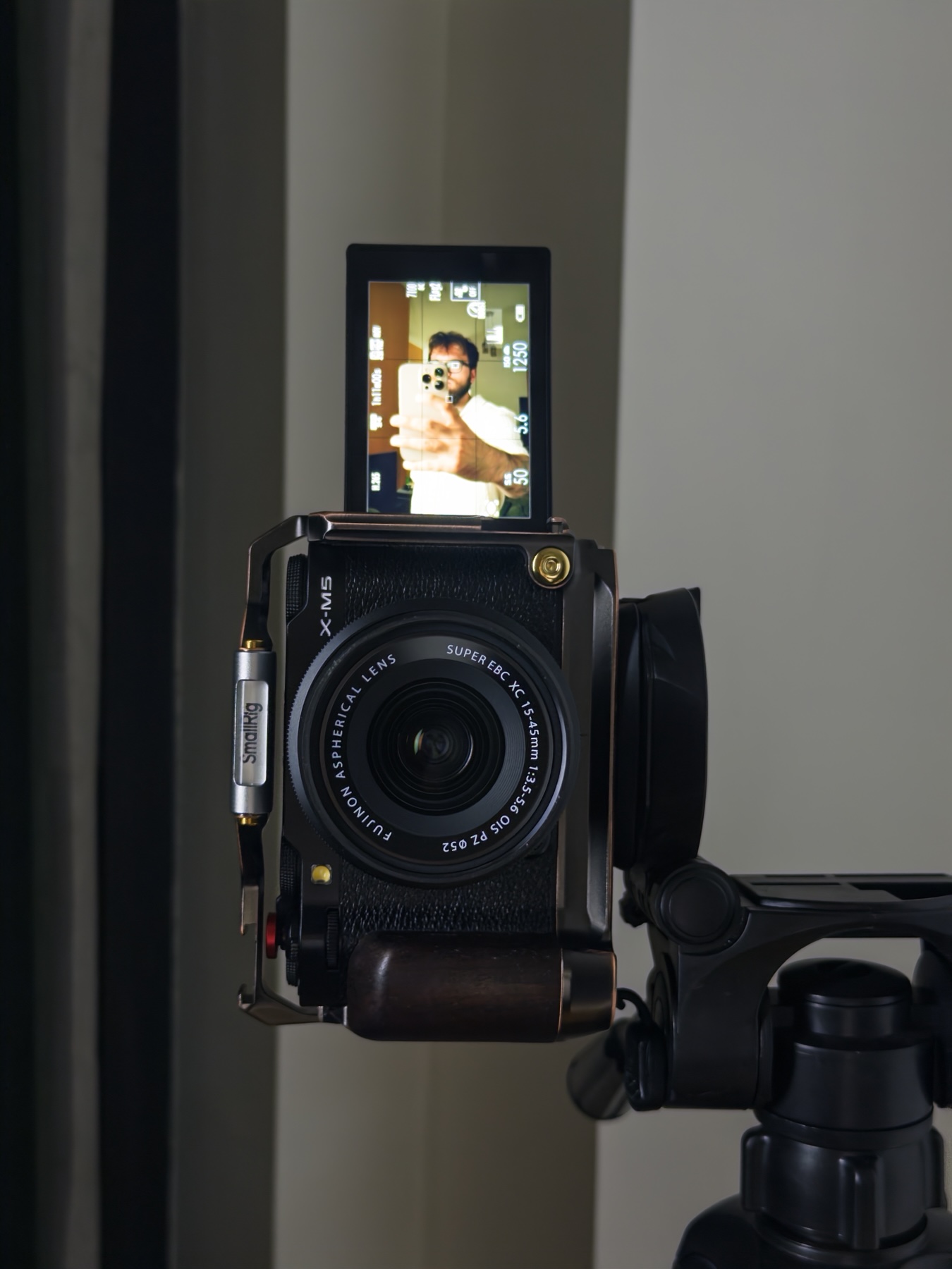 A Fujifilm X-M5 on a tripod, with Denis visible on its camera screen.